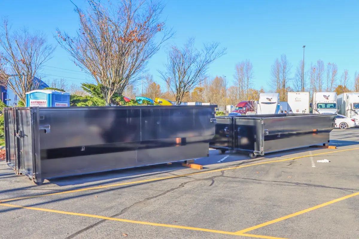 Professional dumpster rental service with roll-off container on residential driveway in Ellensburg